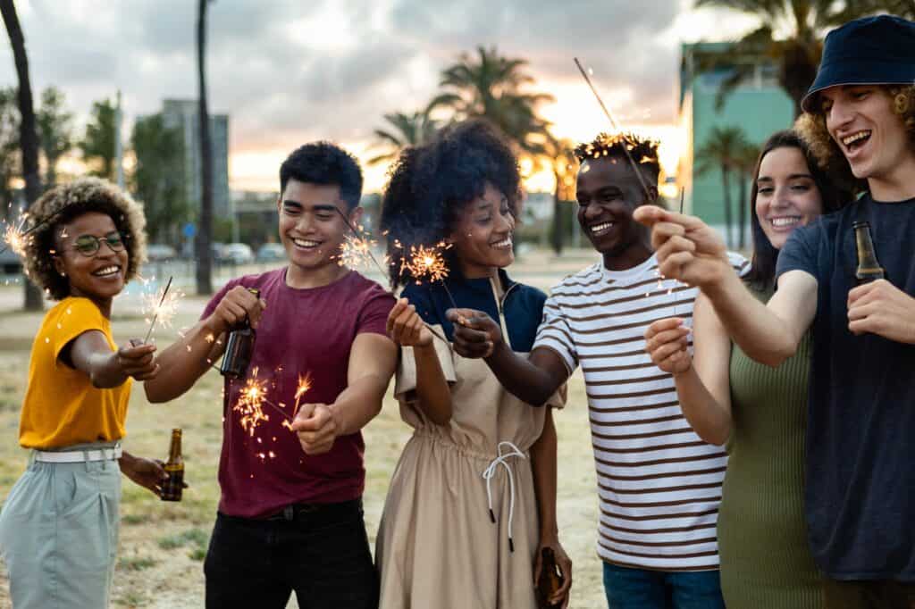 Multicultural united group of young friends having party together