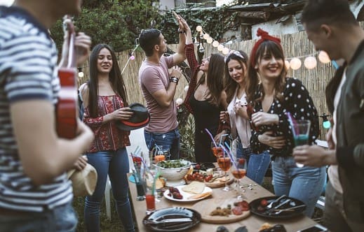 Group of friends having dinner party in backyard